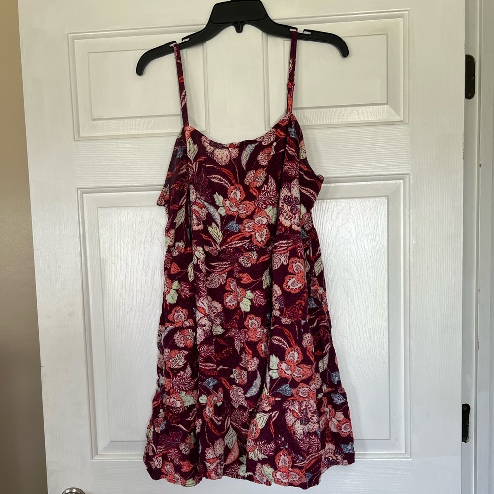 Jewel toned leaf print dress with tiered skirt and adjustable straps.